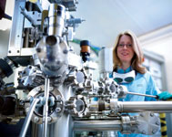 STFC’s Dr Emma Springate, one of the research team, with the Artemis laser. (Credit: Monty Rakusen Photography).